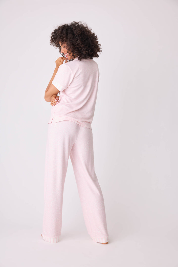 Women's 3-piece pajama set in light pink-ivory leopard dot. Short sleeve button-front top & open leg pant with contrast pink striped cuffs. Includes matching hair wrap. Exclusive collab with Susan G. Komen style.