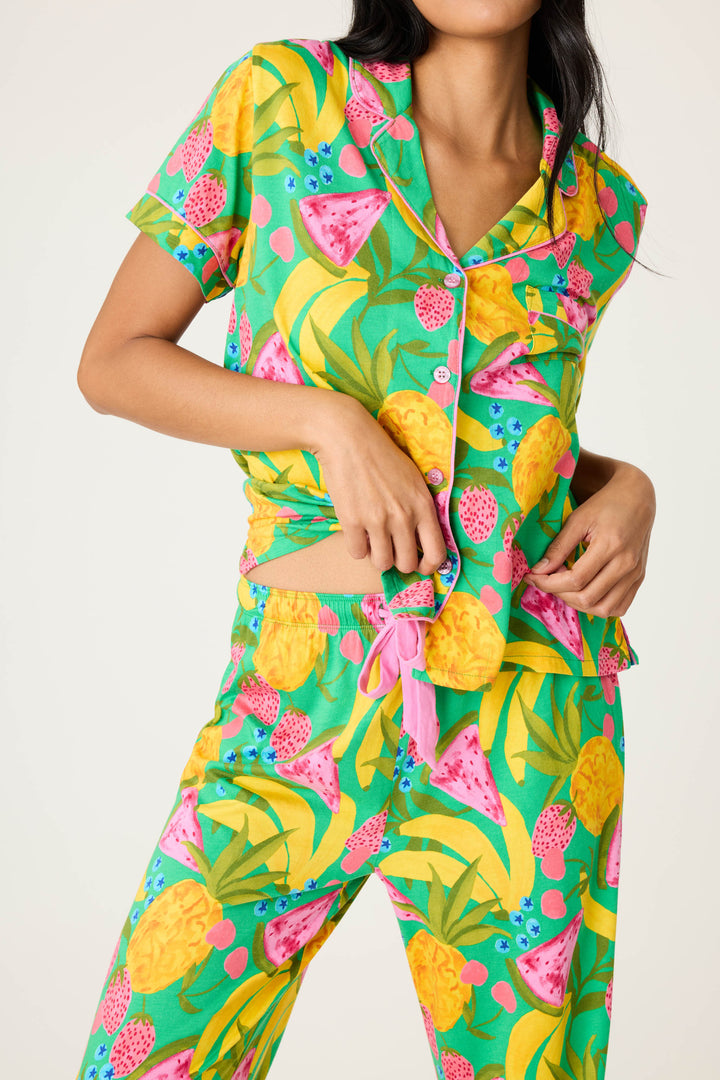 Women's breathable cotton-modal jersey short sleeve pajama set in multicolor fruit print with contrast pink piping. Button-front top & open leg tie-waist pant.