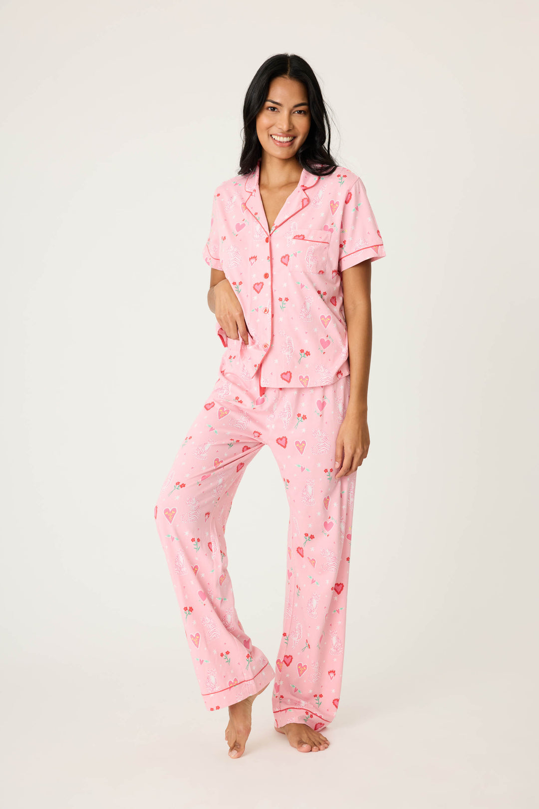 Women's breathable cotton-modal jersey short sleeve pajama set in pink mini tiger & heart print with contrast red piping. Button-front top & open leg tie-waist pant.