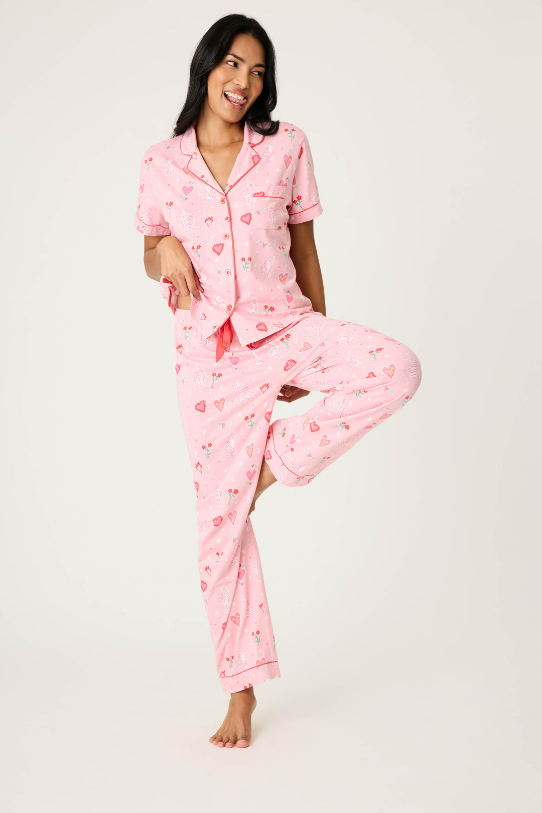 Women's breathable cotton-modal jersey short sleeve pajama set in pink mini tiger & heart print with contrast red piping. Button-front top & open leg tie-waist pant.