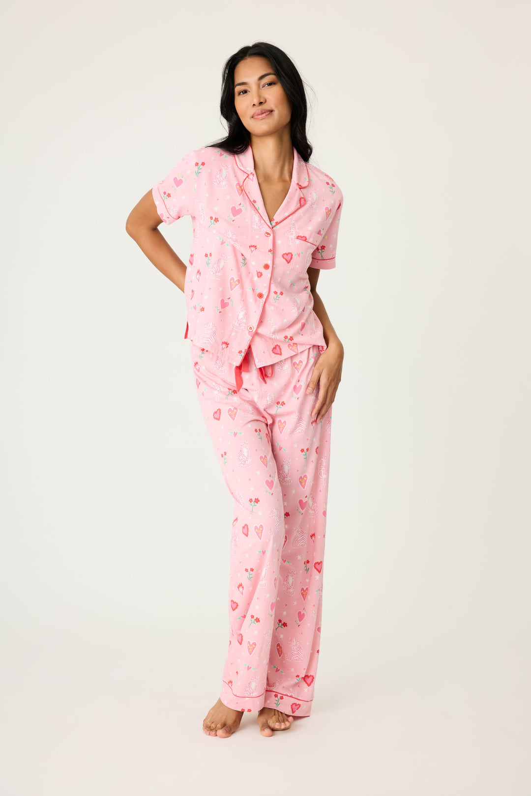 Women's breathable cotton-modal jersey short sleeve pajama set in pink mini tiger & heart print with contrast red piping. Button-front top & open leg tie-waist pant.