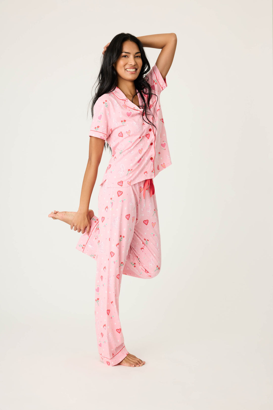 Women's breathable cotton-modal jersey short sleeve pajama set in pink mini tiger & heart print with contrast red piping. Button-front top & open leg tie-waist pant.