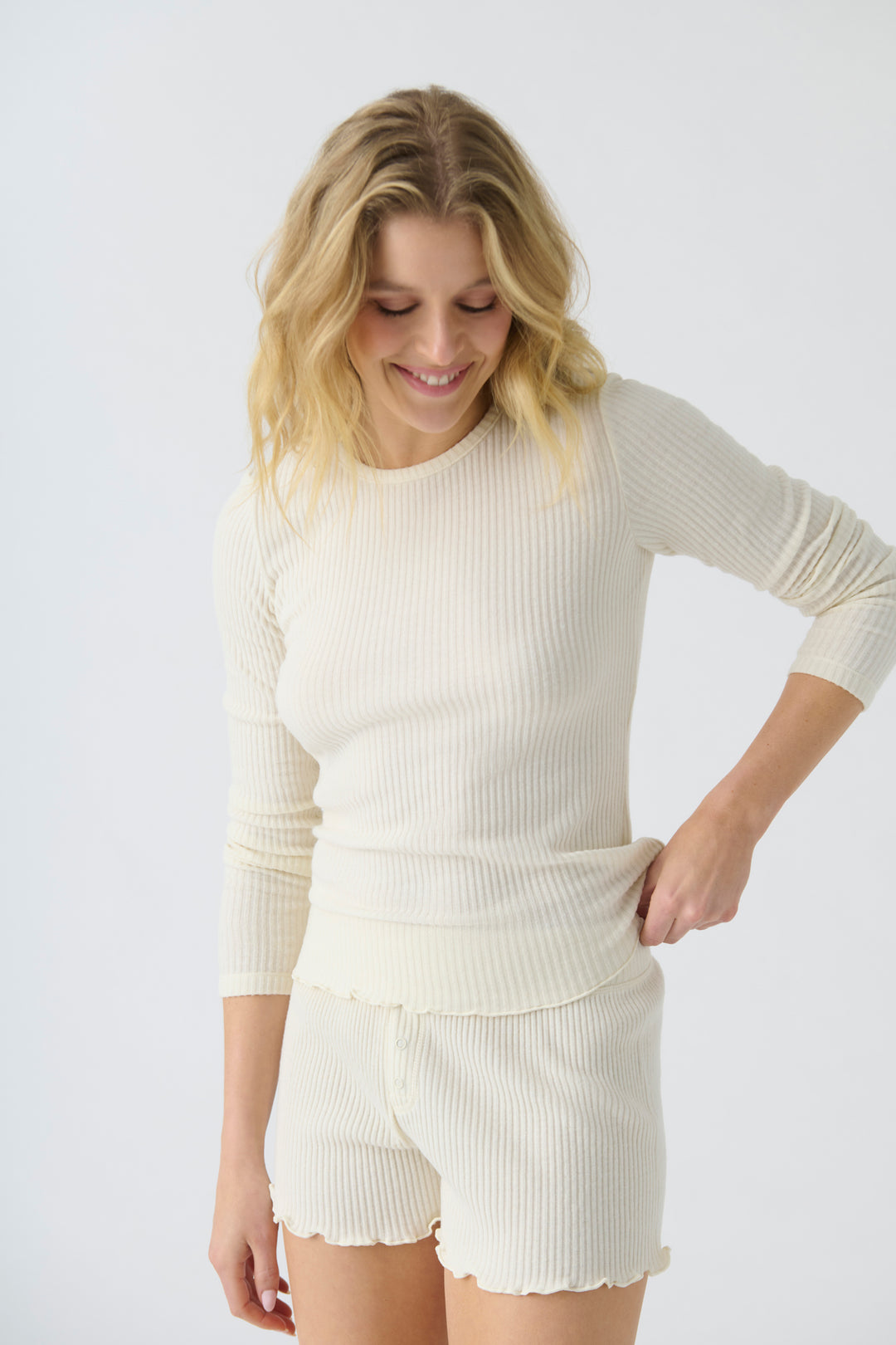 Women's ivory rib knit fitted long sleeve top & curly-edge hem