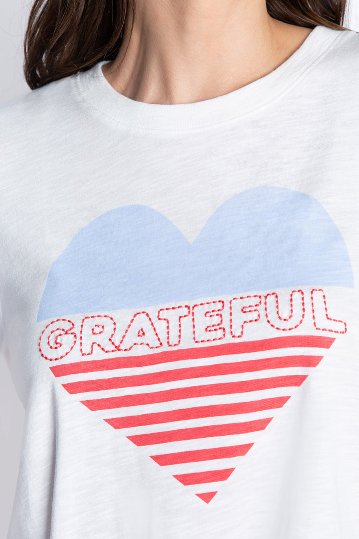 Women's ivory t-shirt with blue & red 'Grateful' heart graphic print front.