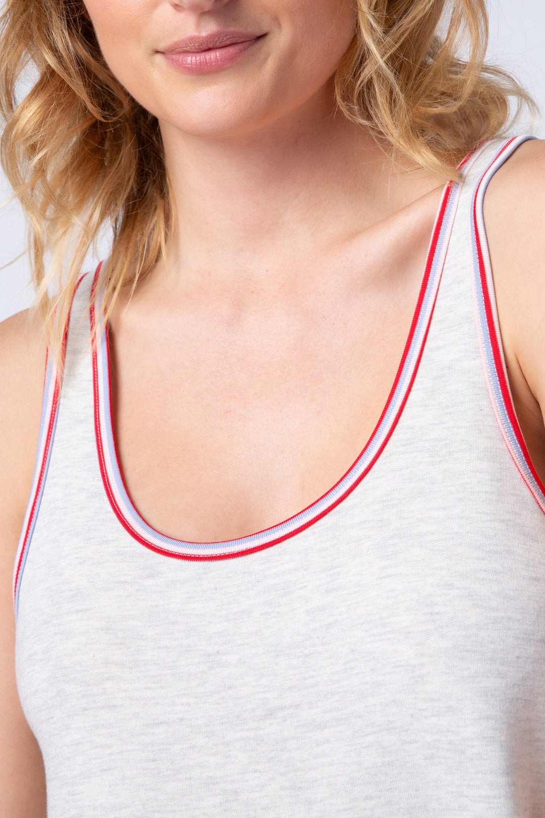Women's light grey U-neck tank top, with red & blue piping at neck.
