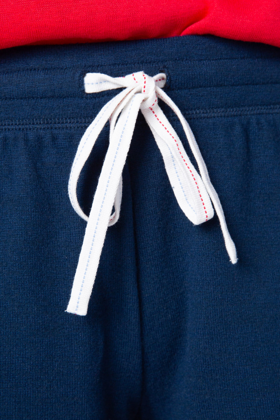 Women's navy blue lounge short w/white & red whipstitching & tie waist.