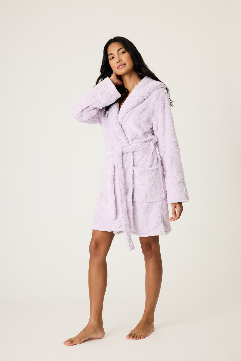 Women's cozy plush hooded robe in lavender with embossed heart pattern.