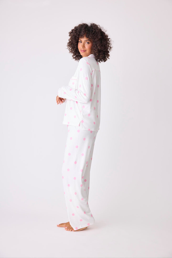 Women's ivory pajama set with pink happy face pattern. Exclusive PJS x Susan G Komen style.