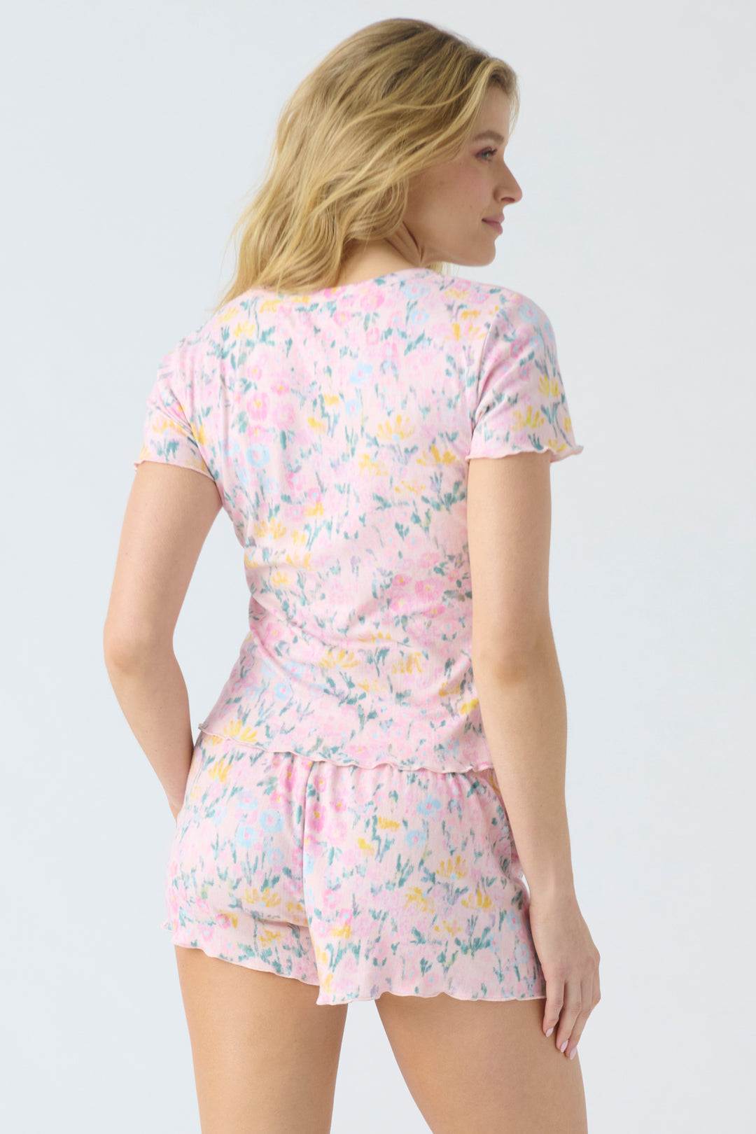 Women's pajama set in pink floral print pointelle. Short sleeve button top & pj short.