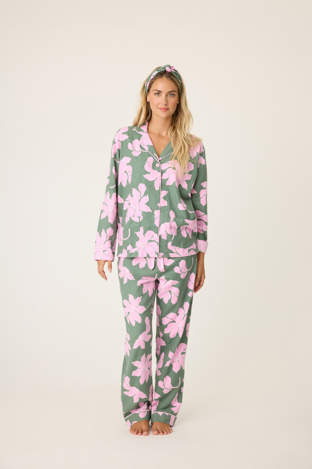 Women's cotton flannel pajama set in green & pink poinsettia print. Button-front collared top & tie-waist pant. Embroidered sleeve cuff "Find Peace Within". Includes matching hair wrap.