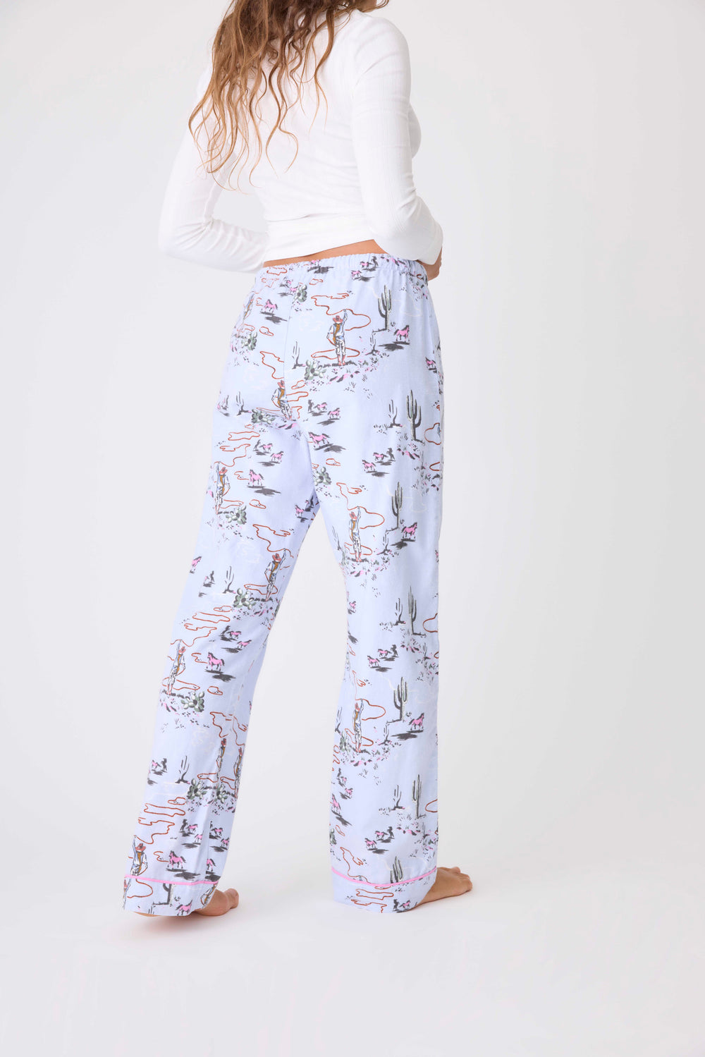 Women's cotton flannel pajama pant in light blue horse-western print. Tie waist.