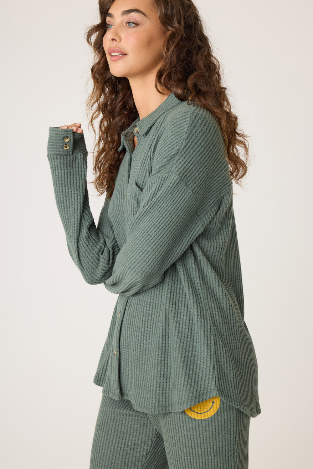 Women's dark green thermal button-front shirt with collar. Chest pocket & curved hem.