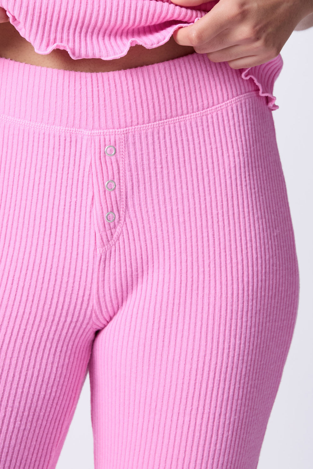 Pink rib high-waisted pant in Repreve x Reloved recycled soft knit. Banded waist with mini-snap fly.