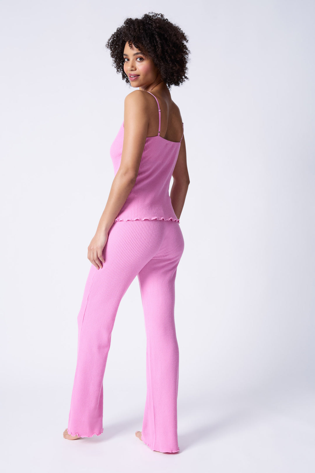 Pink sleep set camisole top & high-waisted pant. Made in Repreve x Reloved recycled soft knit.