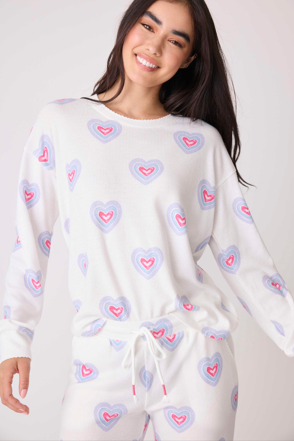 Women's long sleeve pj top in ivory heart-print on pointelle knit. Open hem.