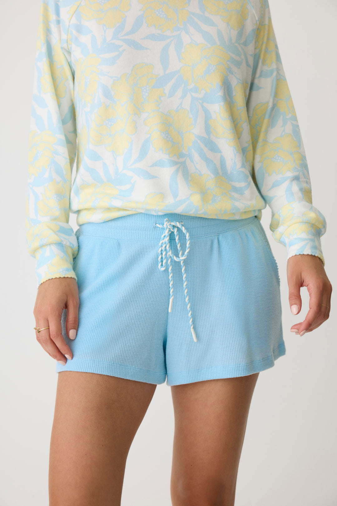 Women's short in light blue baby waffle knit with side pockets & multi-twist drawcord.