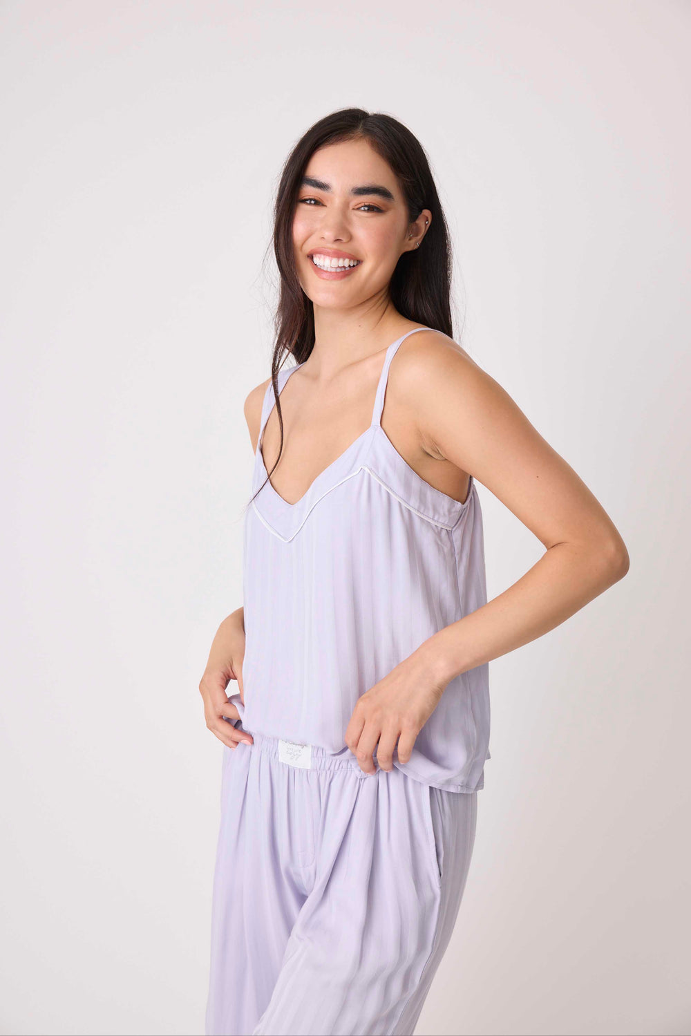 Women's woven camisole top with V-neck & adjustable straps. In lavender shadow stripe.