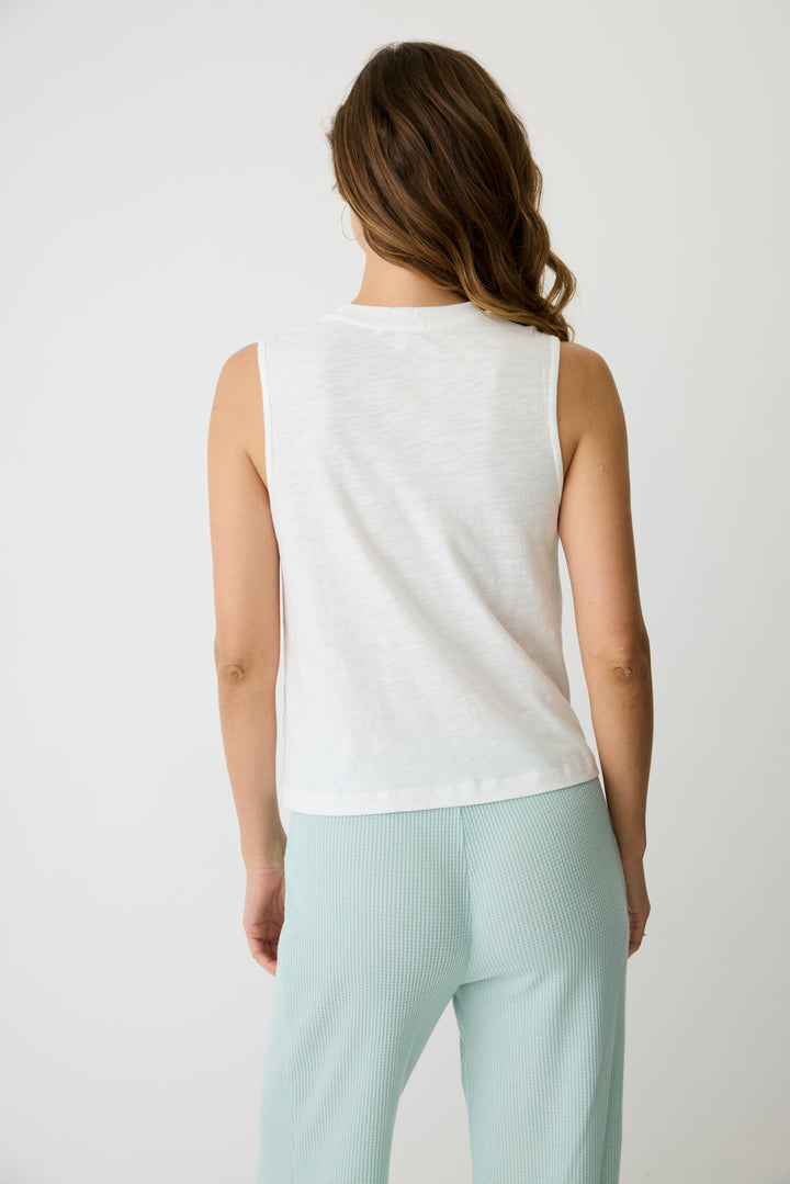 Women's ivory graphic print tank top with open hem. 'Take it easy' print on chest.