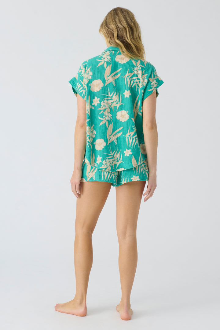 Women's short sleeve cotton woven gauze with green tropical print. Button-front with chest pocket.