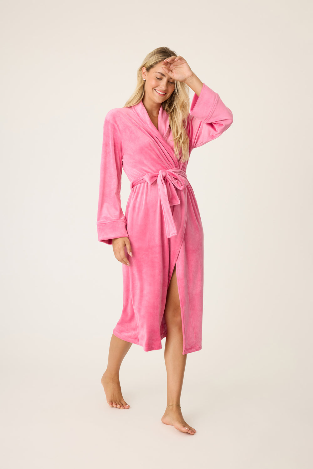 Women's 3/4 length fuschia robe in velvety velour. Self belt & comfy patch pockets.