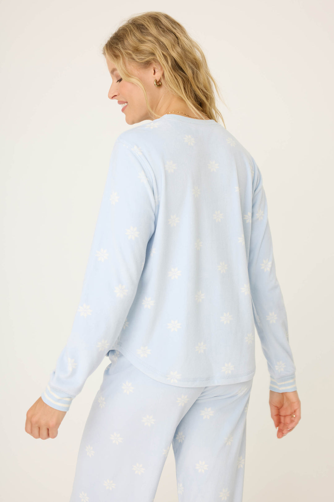 Women's long sleeve pale blue PJ top with white snowflake pattern.