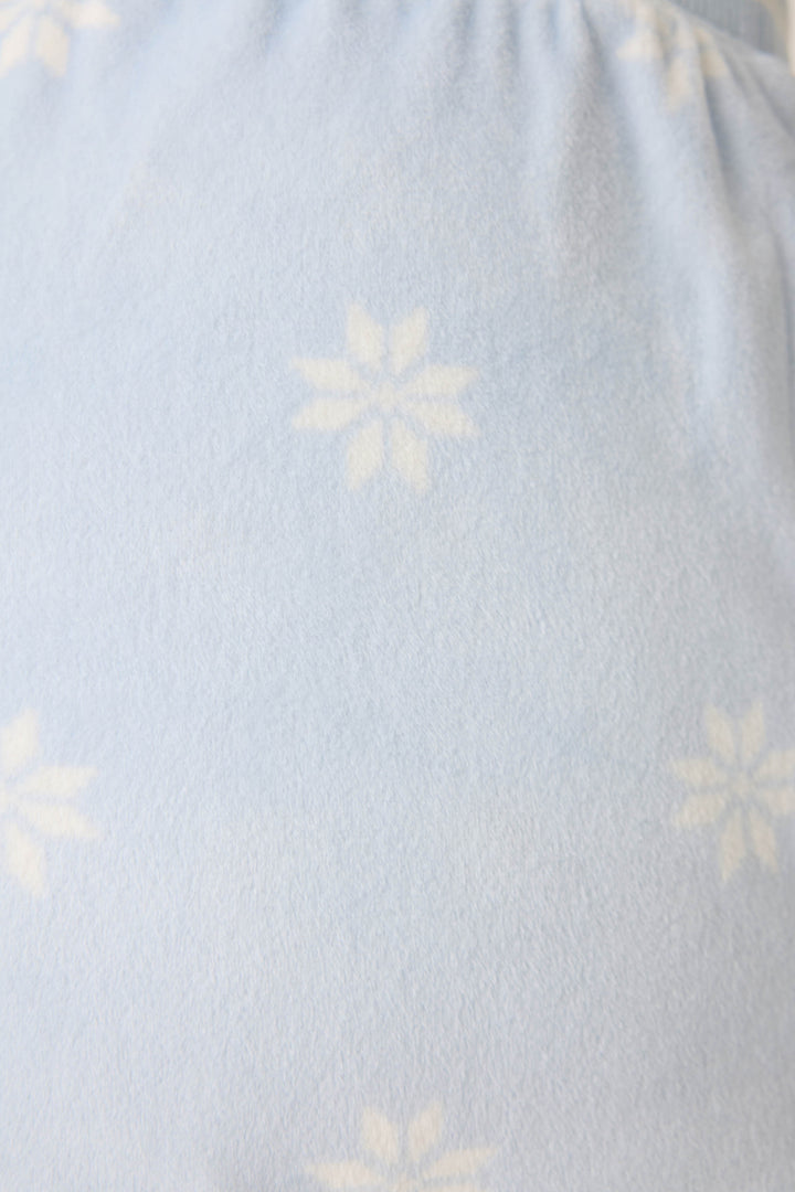 Women's long sleeve pale blue PJ top with white snowflake pattern.