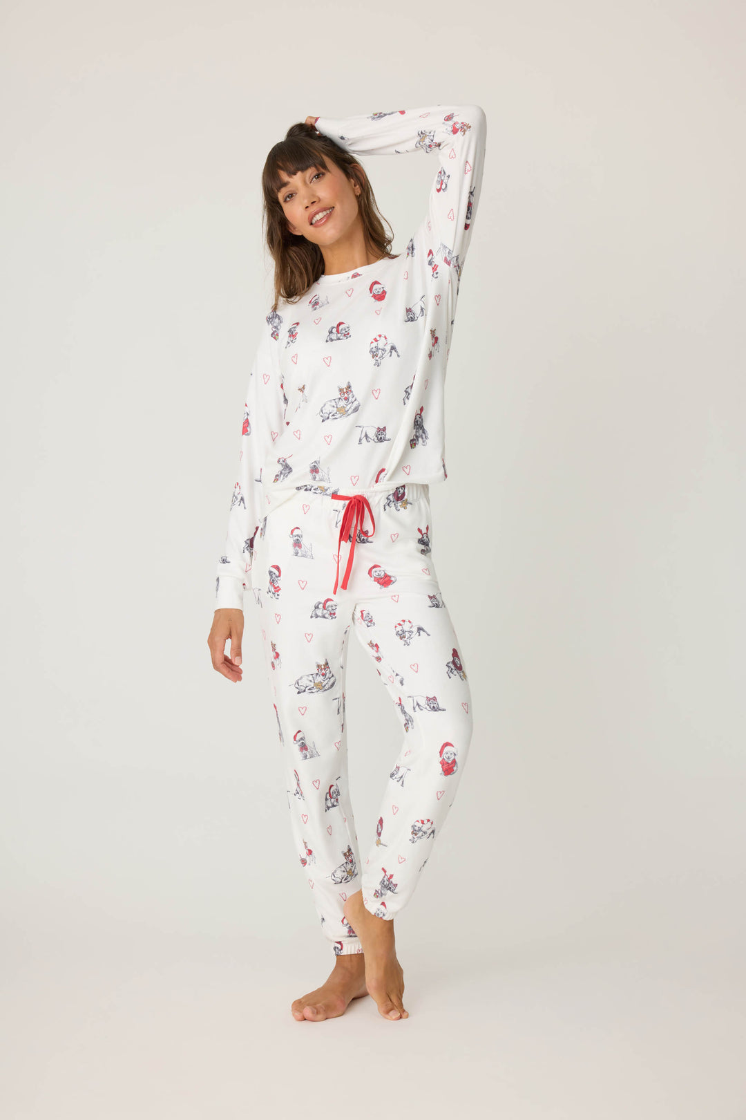 Women's white jammie top and banded PJ pant with holiday dog with red hats pattern.