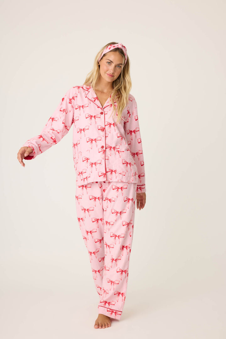 Women's pink PJ top and tie-waist pant with pink bow pattern.