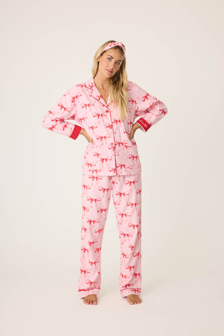 Women's pink PJ top and tie-waist pant with pink bow pattern.