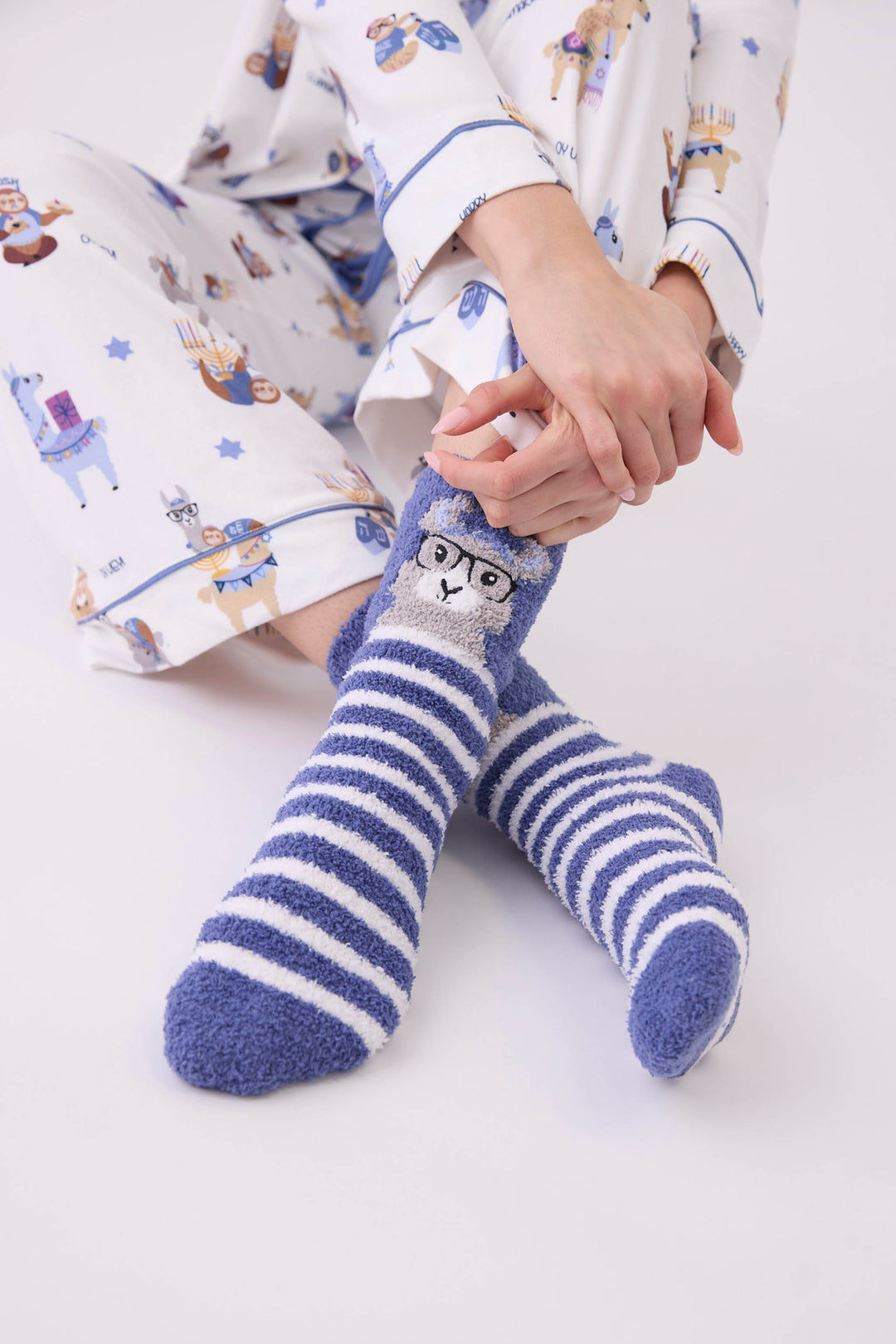 Women's blue and white striped socks with llama detail.