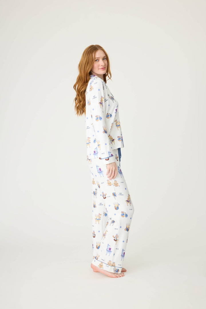 Women's white collared PJ top and tie waist pant with Hanukkah llama pattern.