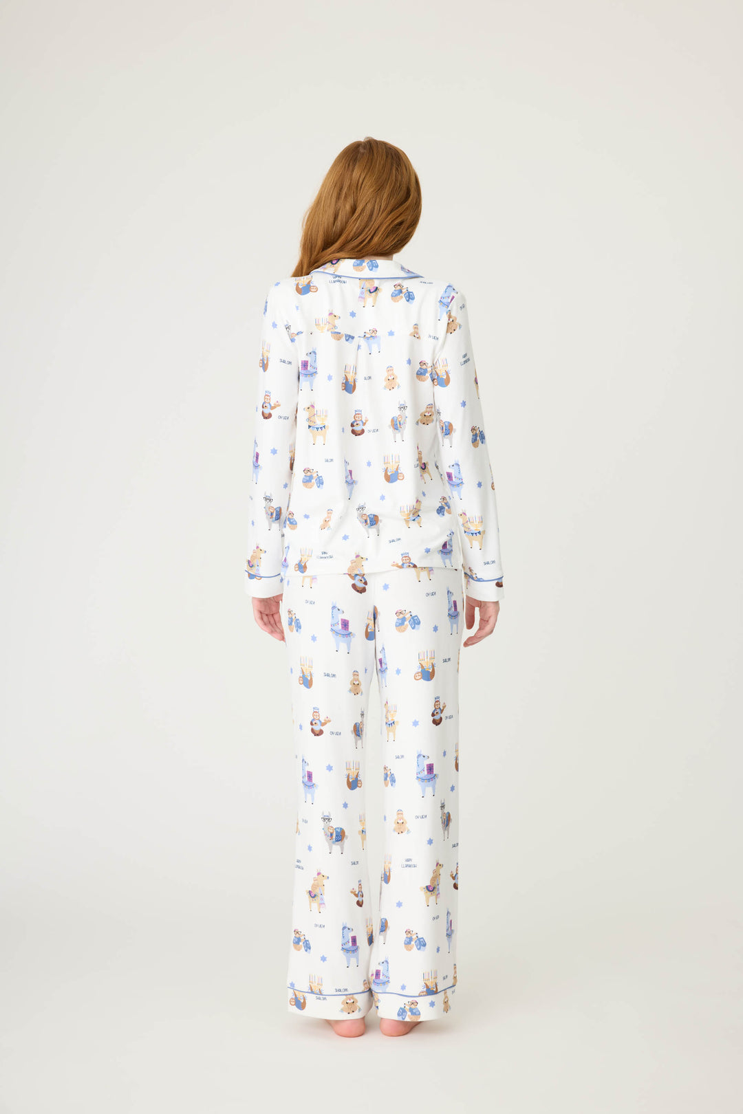 Women's white collared PJ top and tie waist pant with Hanukkah llama pattern.