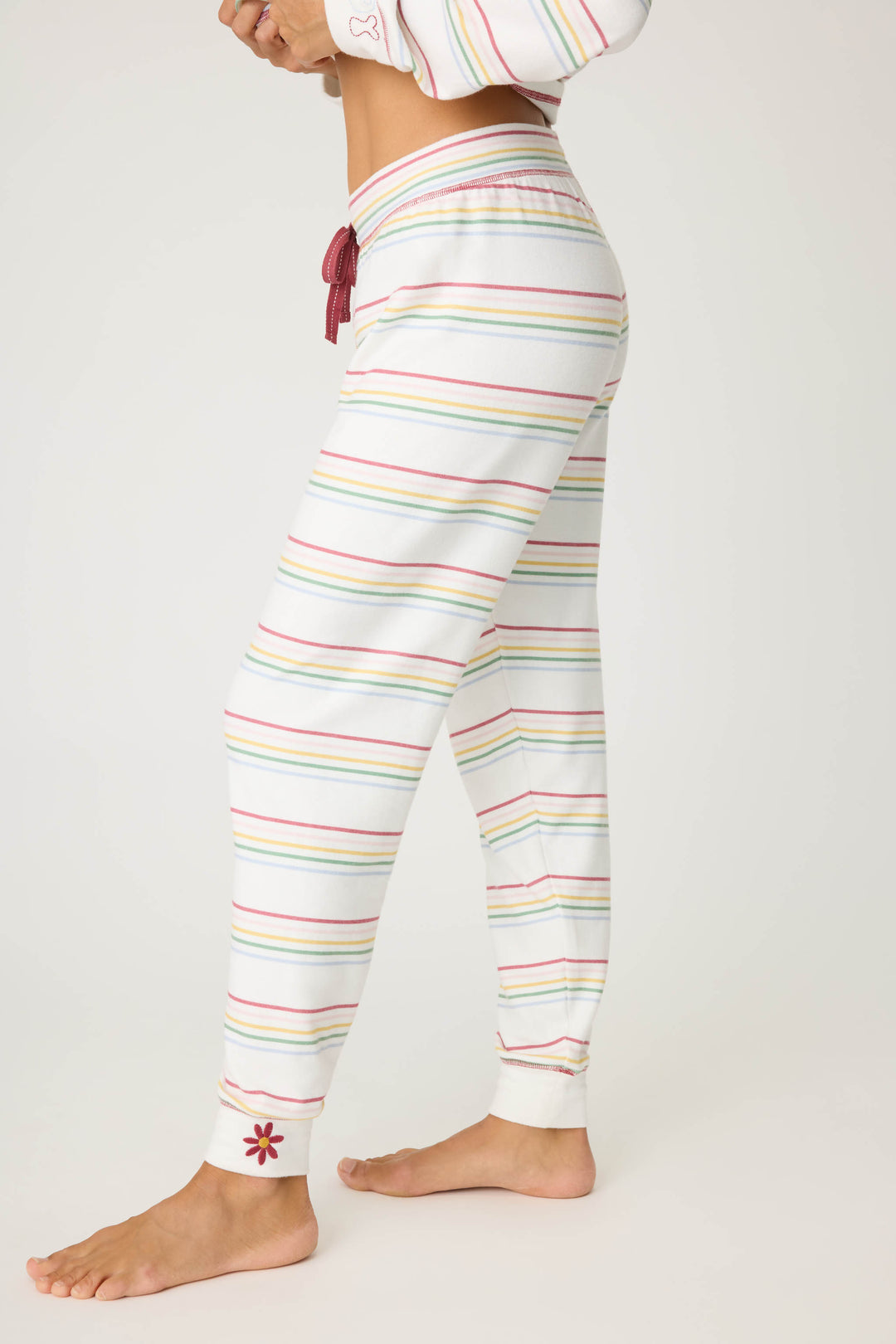 Women's white and multi-color stripe banded PJ pant with tie waist and flower embroidery on ankle.