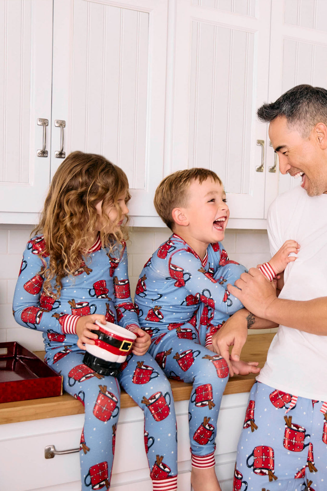 Kids blue PJ long sleeve and banded pant with red hot cocoa mug pattern.