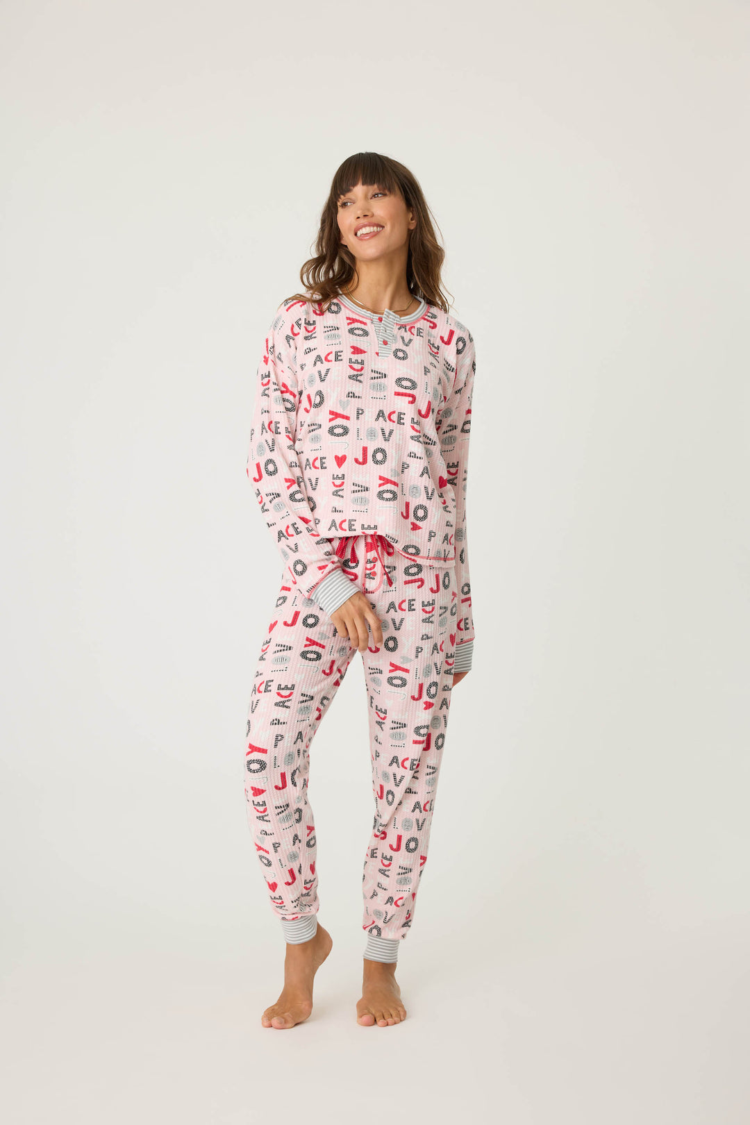 Women's pale pink jammie top and banded PJ pant with joy and peace pattern.