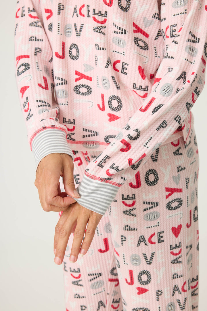 Women's pale pink jammie top and banded PJ pant with joy and peace pattern.