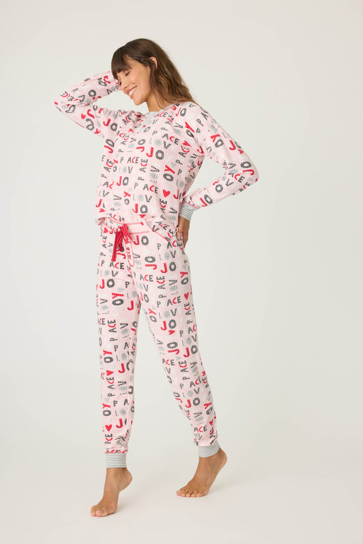 Women's pale pink jammie top and banded PJ pant with joy and peace pattern.