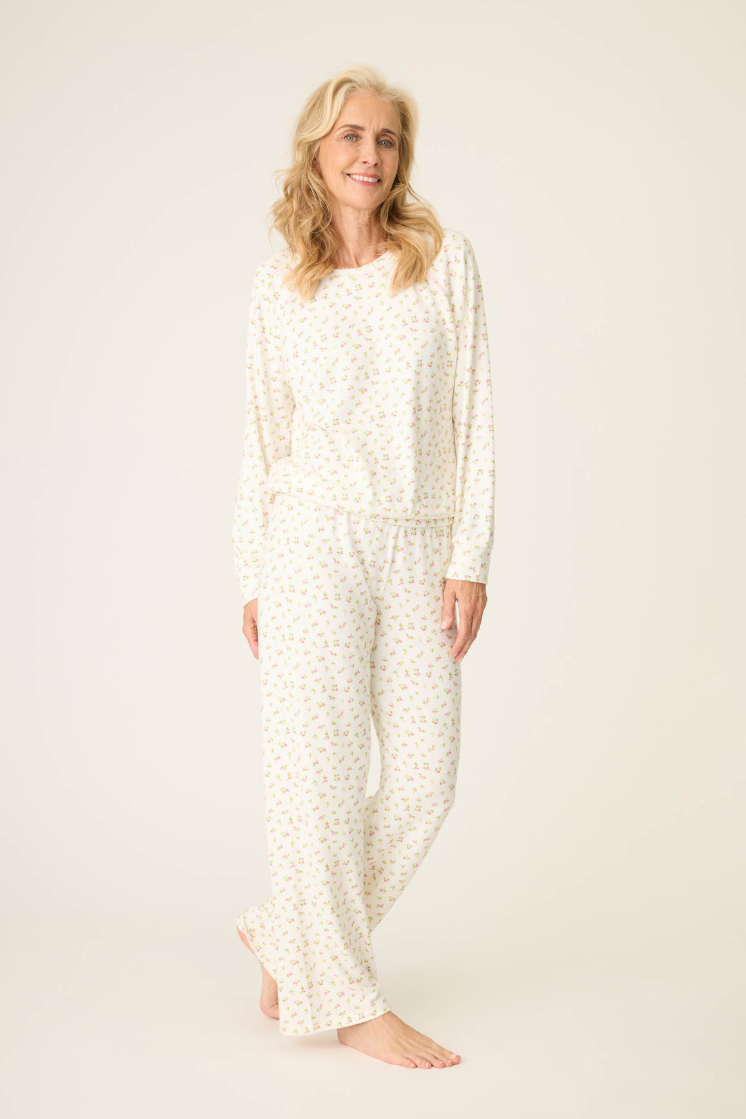 Women's ivory long sleeve pj shirt and banded pj pants with pink floral pattern.