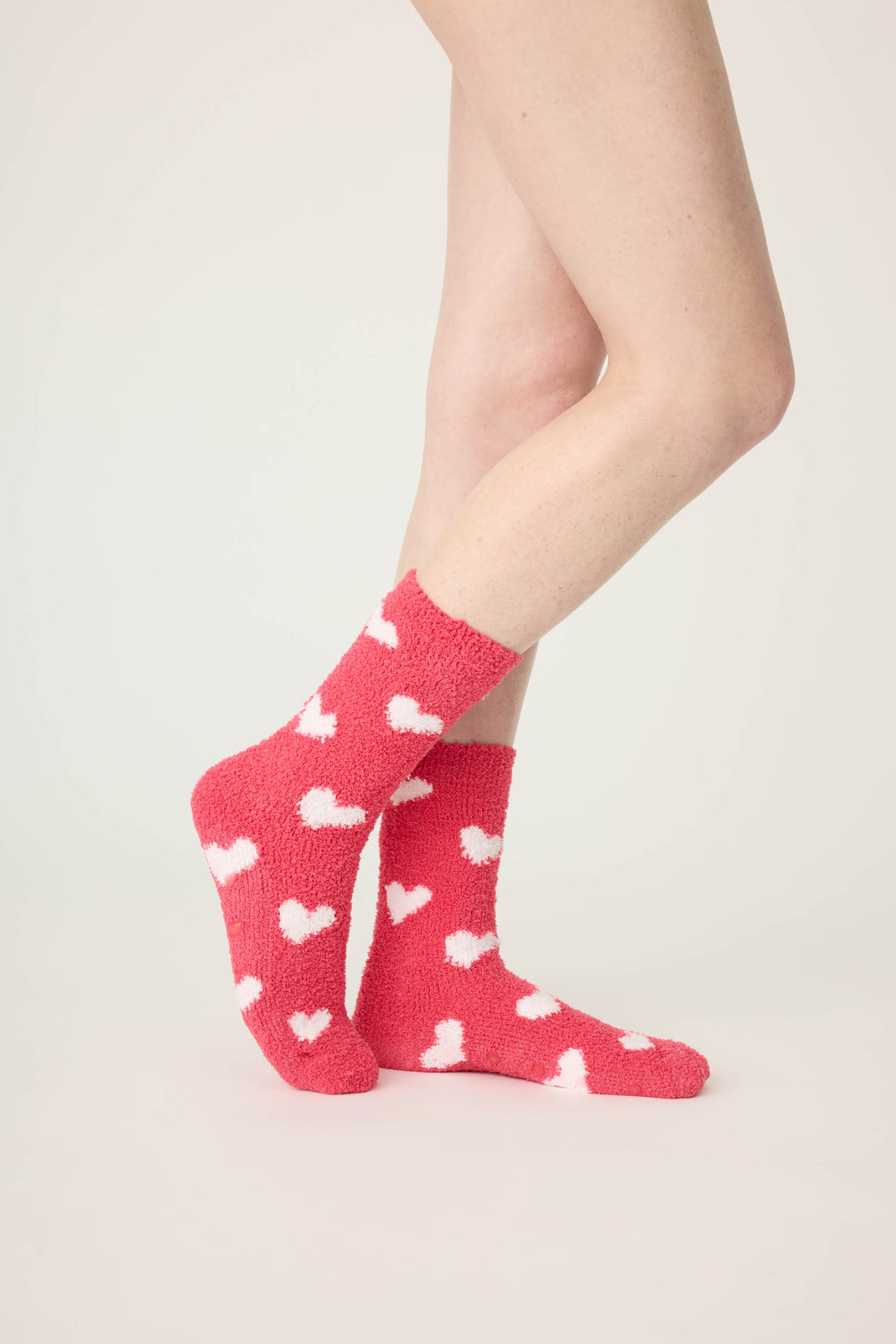 Women's red socks with white heart pattern.