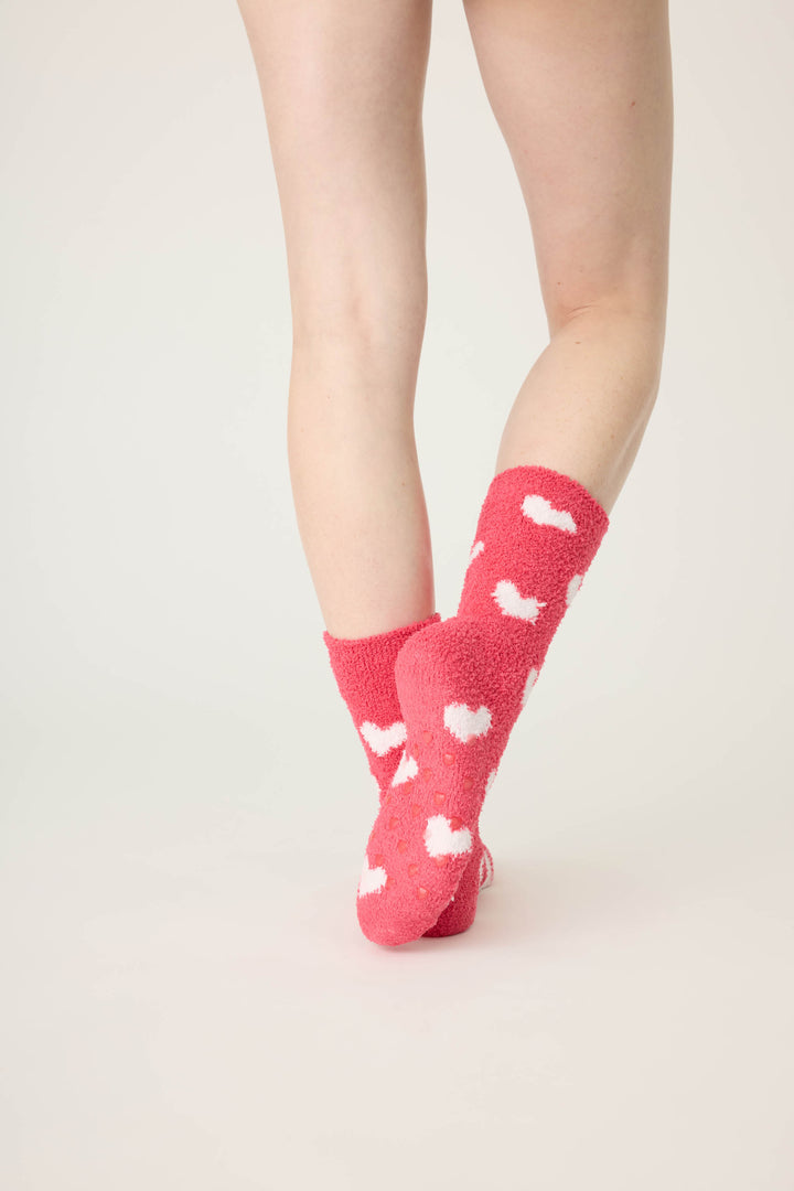 Women's red socks with white heart pattern.