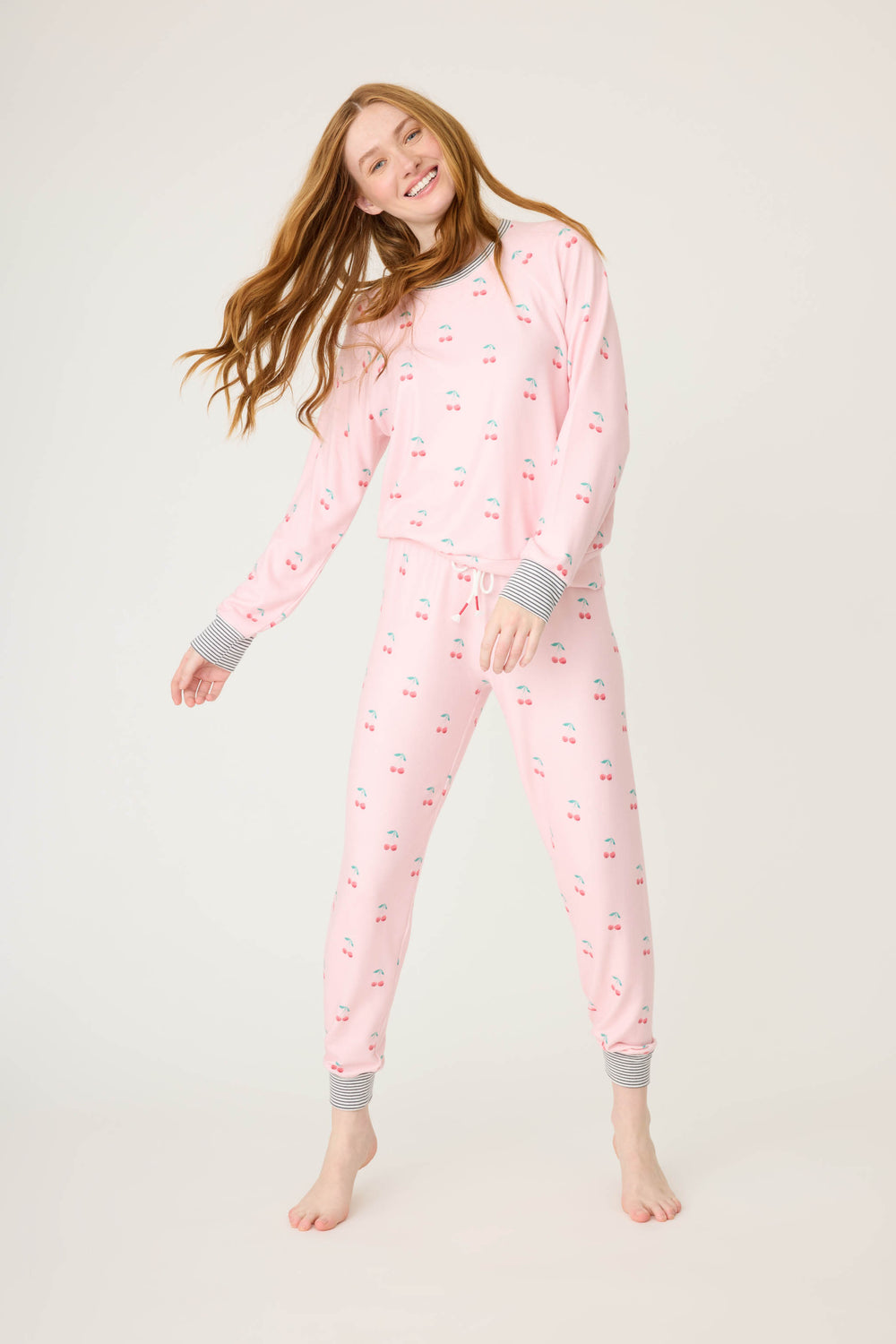 Women's pink jammie top and banded pj pant with cherry pattern.