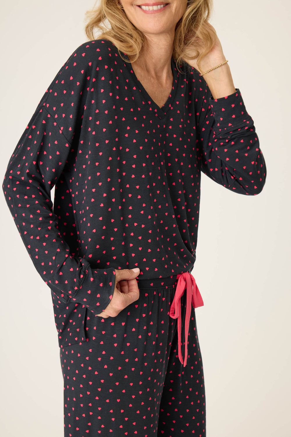 Women's black long sleeve pj top with pink heart pattern.