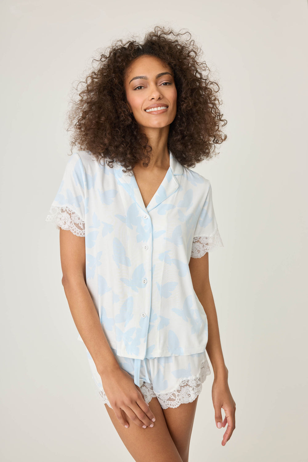 Women's pajama short set in ivory-blue butterfly printed modal jersey. Button front short sleeve top & tie waist short.