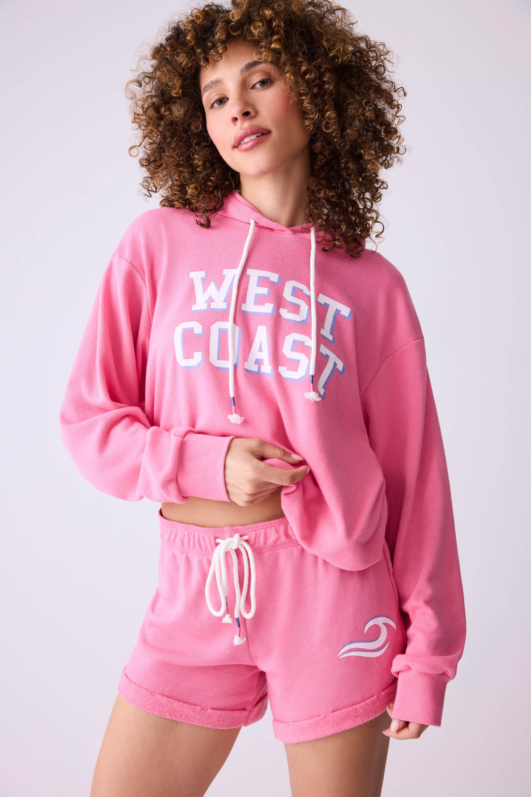 Women's vintage fleece jogger set in pink with WEST COAST graphic print.