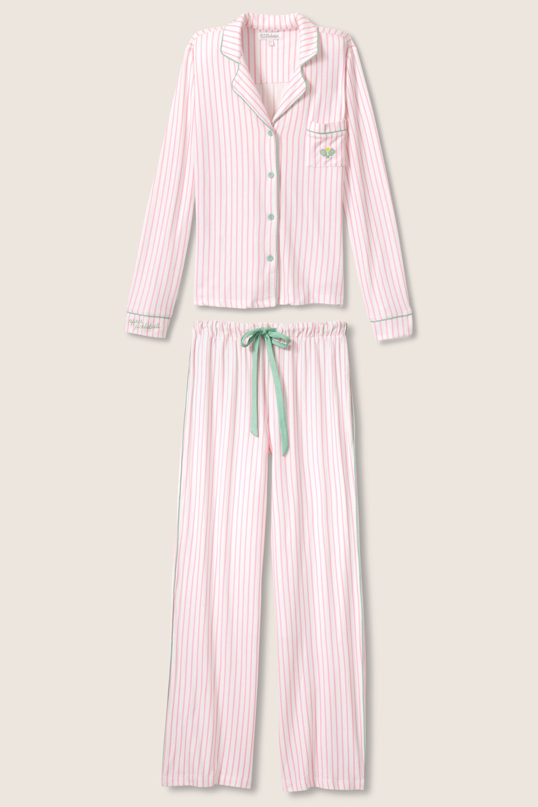 Ivory & pink striped pajama set in butter jersey. Button front top & tie pant have contrast pink piping. Includes embroidered eyemask "Apres Pickelball". Chest pocket with embroidery.