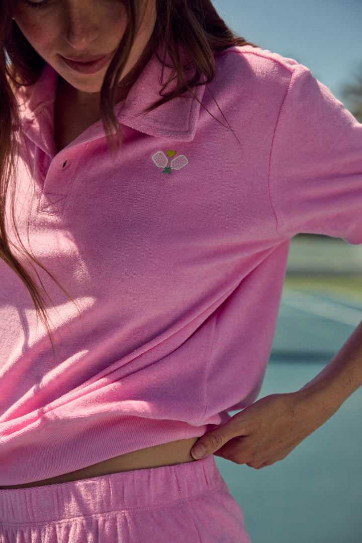 Women's pink vintage terry short sleeve polo top with button placket-collar & embroidery on chest.