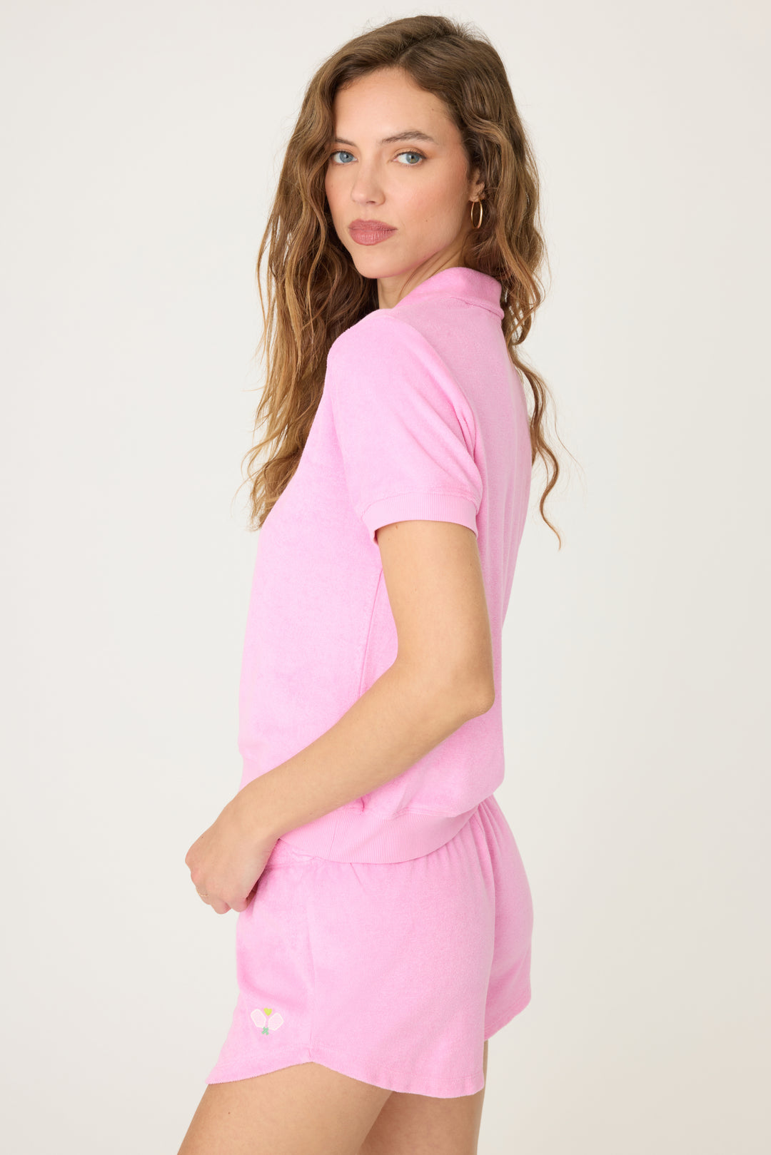 Women's pink vintage terry short sleeve polo top with button placket-collar & embroidery on chest.