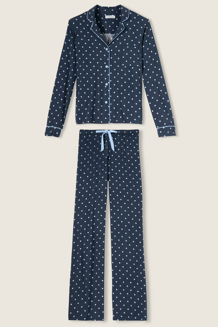 Women's navy blue w/ivory polka dot pajama set in modal jersey. Top is button-front with collar & contrast piping. Pant has tie waist & contrast piping on sideseams.