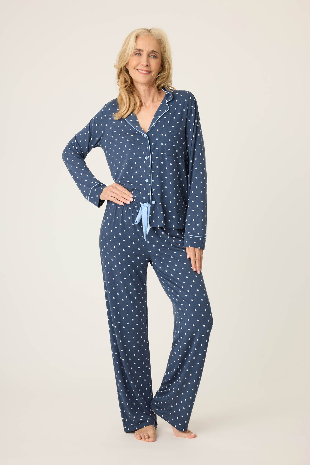 Women's navy blue w/ivory polka dot pajama set in modal jersey. Top is button-front with collar & contrast piping. Pant has tie waist & contrast piping on sideseams.