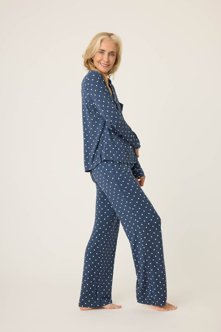 Women's navy blue w/ivory polka dot pajama set in modal jersey. Top is button-front with collar & contrast piping. Pant has tie waist & contrast piping on sideseams.